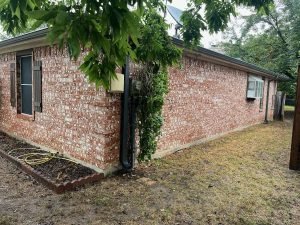 dark gutters on red and white brick home